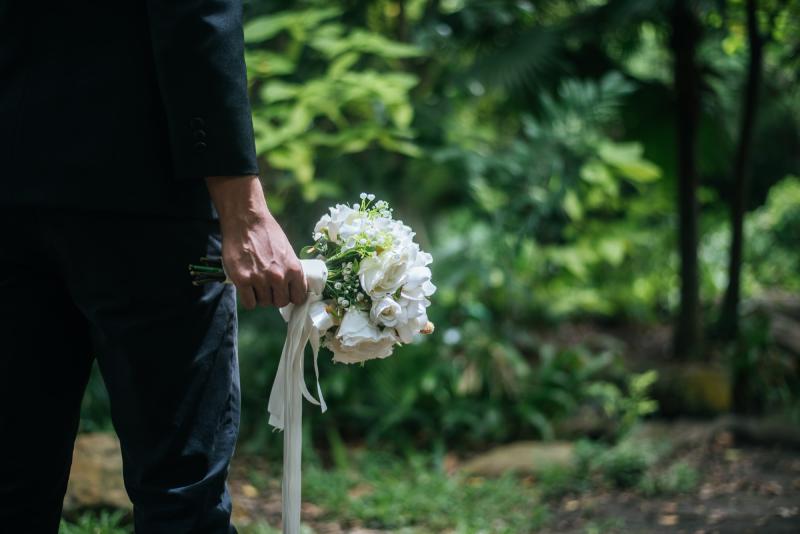 Beautiful bouquet in the hands of the groom for bride